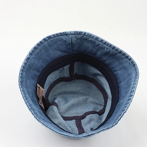 Inside view of blue washed denim bucket hat with sweatband and ADMENT label detail