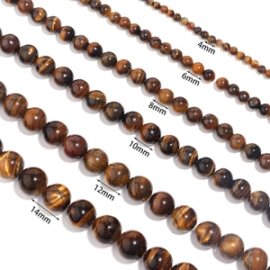 Detailed view of natural tiger eye beads in various sizes from 4mm to 14mm for DIY jewelry
