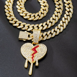 Golden hip hop Cuban chain with sparkling iced out broken heart and blood drop pendant
