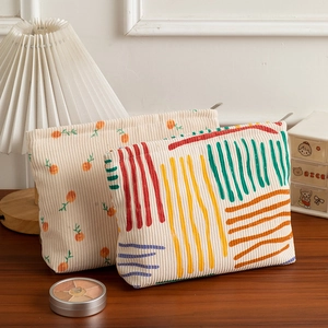 Close-up of floral corduroy makeup bags showing high-quality texture and metal zippers