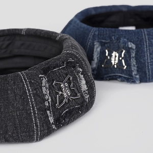 Macro view of denim headbands with silver butterfly emblem and frayed patch details
