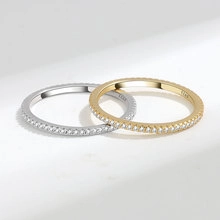 Macro shot of silver and gold S925 sterling silver rings with exquisite paved diamonds