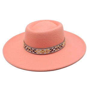 Detail view of pink wool felt hat with ethnic geometric floral woven band