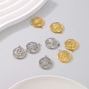Detailed macro view of 18K gold and silver celestial pendants with embossed sun and moon