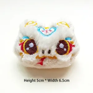 Macro view of white plush snake doll with embroidery, 5cm height by 6.5cm width dimensions