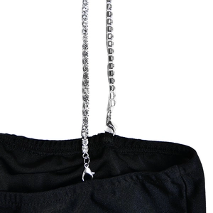 Close-up of sparkling rhinestone chain strap with lobster clasp on black dress detail