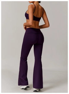 Close-up of dark purple yoga set featuring thin straps sports bra and flared yoga pants