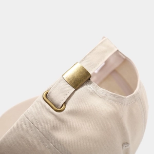Premium beige baseball cap with adjustable brass metal buckle and cotton twill texture