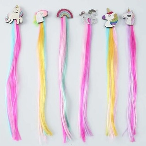 Detail of 6-piece girls' unicorn and rainbow hair clips with long colorful wig extensions