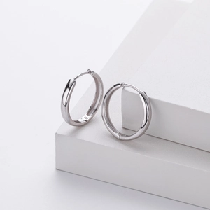 Detailed macro view of S925 sterling silver earrings showing the hallmark stamp and polish