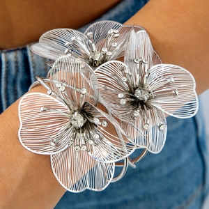 Exaggerated silver flower cuff bracelet with sparkling rhinestones and hollow metalwork