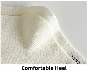 Close-up of white breathable waffle knit cotton socks with black SOCKS lettering