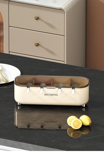 Detail view of cream kitchen spice box set with transparent lid and four spoons on marble