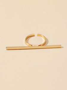 Detail showing the polished gold rectangular bar and adjustable open band of the ring