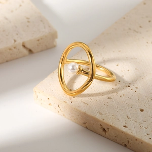 Elegant 18k gold stainless steel oval pearl ring on a natural beige stone background