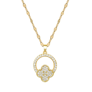 Macro detail of gold-plated clover pendant with sparkling crystals on a textured chain