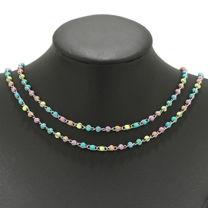 Close-up of stainless steel chain with colorful enamel beads on a neck mannequin