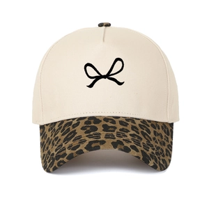 Close-up of leopard print brim and bow embroidery on 5-panel cotton baseball cap