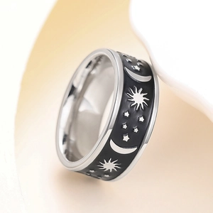 Star and moon engraved silver ring with black enamel inlay and celestial patterns