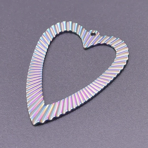 Detailed macro view of heart-shaped rainbow pendant with textured metallic finish