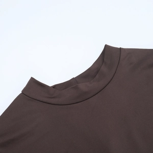 Close-up of deep brown mock neck dress showing fabric texture and shoulder seams