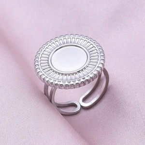 Macro shot of silver stainless steel adjustable ring with sunray coin relief detail