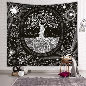 Detail of bohemian Tree of Life tapestry with sun and moon phases on white brick wall