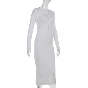 Close-up of white knitted dress featuring lace-up V-neck and wave-textured ribbing