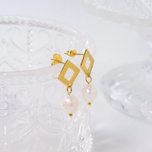 Elegant baroque pearl geometric drop earrings featuring golden diamond-shaped studs