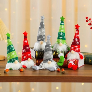Detail of Christmas gnomes with snowflake knitted hats and stars in a warm festive setting