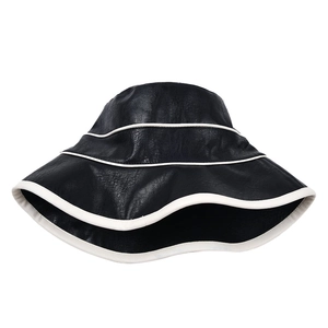 Minimalist black PU leather bucket hat with contrast white trim and textured finish