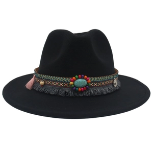 Detailed view of western cowboy hat with ethnic beads, turquoise gem, and pink tassels