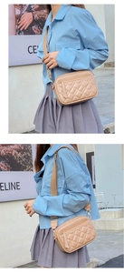 Close-up of a light khaki quilted crossbody bag with golden hardware and fabric strap