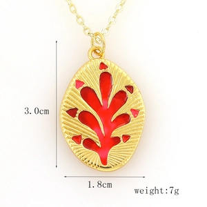 Macro shot of gold oval pendant with red enamel leaf pattern and 3.0cm size dimensions