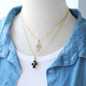 Double-layered hip hop cross necklace with gold chain and zircon pendants on a model