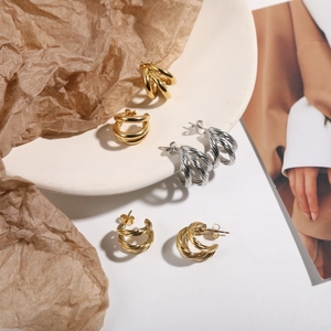 Polished stainless steel geometric hoop earrings in gold and silver finish options