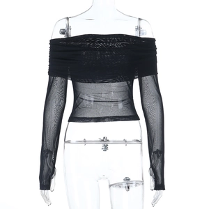 Detail of black off-shoulder mesh top showing layered gathers and sheer fabric texture
