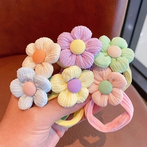 Detailed shot of elastic flower hair ties featuring corduroy petals and colorful centers