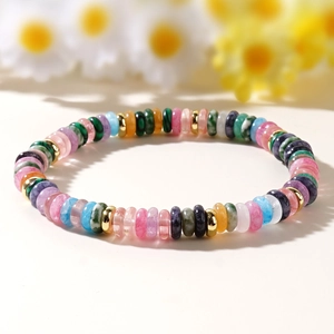 Colorful semi-precious stone bead bracelet with gold spacers on soft floral background