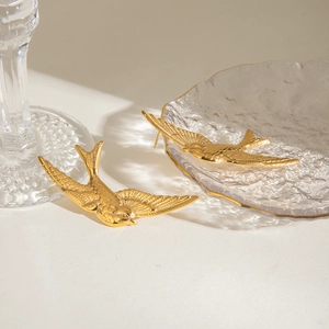 Vintage golden swallow bird stud earrings in stainless steel on elegant white background