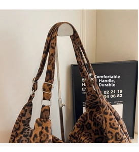 Detail of leopard print tote bag with silver metal ring and adjustable strap buckle