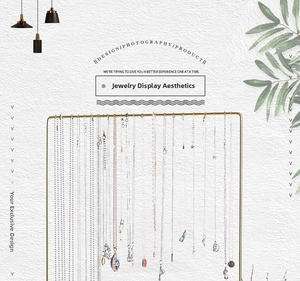Detail showing various necklaces on a gold rectangular metal jewelry display rack