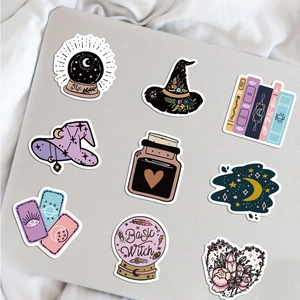 Detailed view of mystic witch stickers with purple and blue themes on a laptop cover