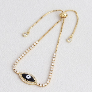 Detail of gold evil eye bracelet with blue stones and adjustable sliding box chain