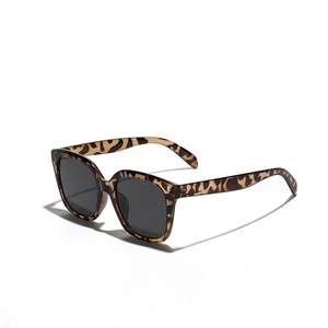 Fashionable square leopard print sunglasses with dark grey lenses in a stylish profile