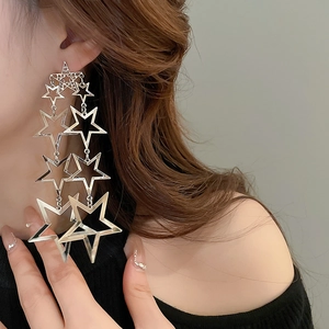 Exaggerated silver star tassel drop earrings with layered metallic pentagon design
