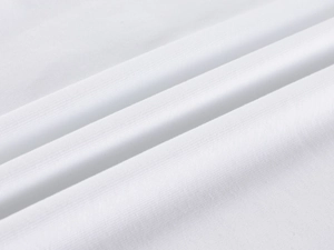 Close-up of white ribbed knit fabric showing soft texture and high-density stitching details