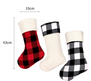 Detailed view of three plaid Christmas stockings with 19cm and 43cm size dimensions