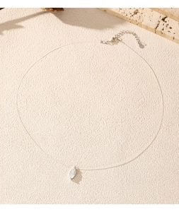 Detailed view of S925 silver leaf pendant on invisible fishline chain necklace