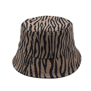Detail of zebra pattern twill cotton bucket hat with black and beige animal print texture